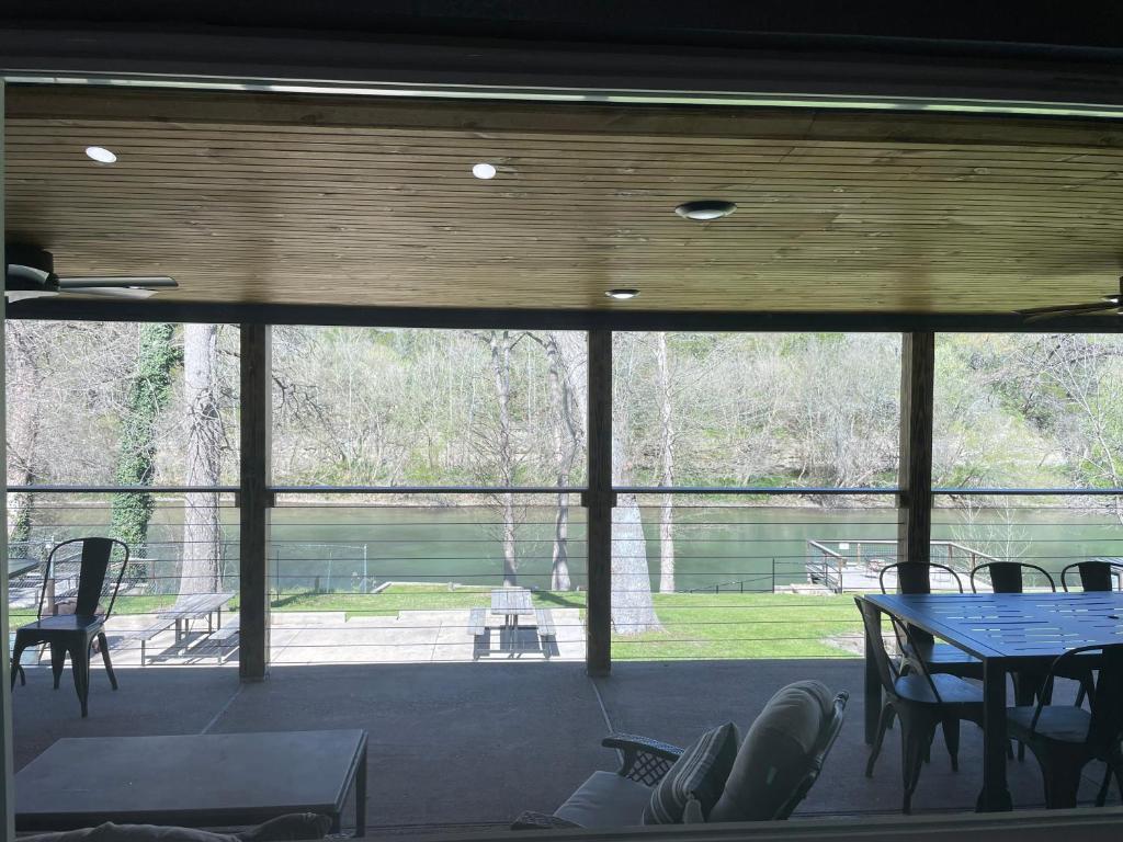 a large window in a room with a table and chairs at Farm House with River Access to Guadalupe River in New Braunfels