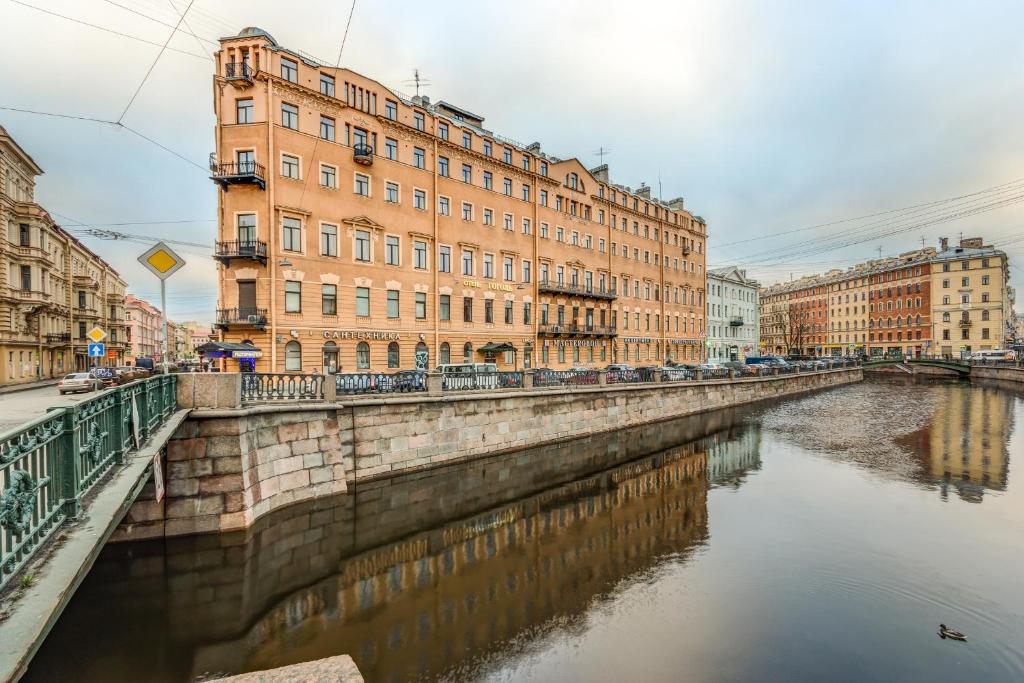 een brug over een rivier in een stad met gebouwen bij Hotel Gogol House in Sint-Petersburg