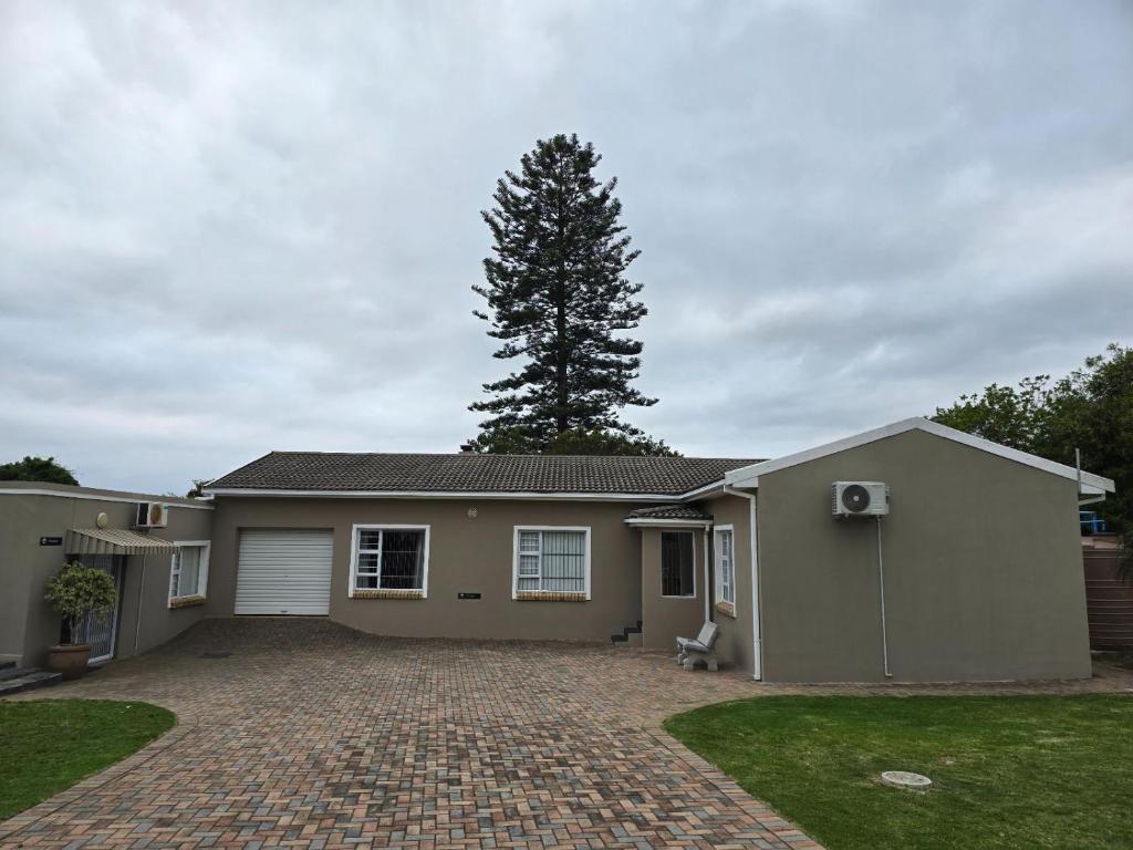 a house with a tree in the back yard at BestInn in Lorraine