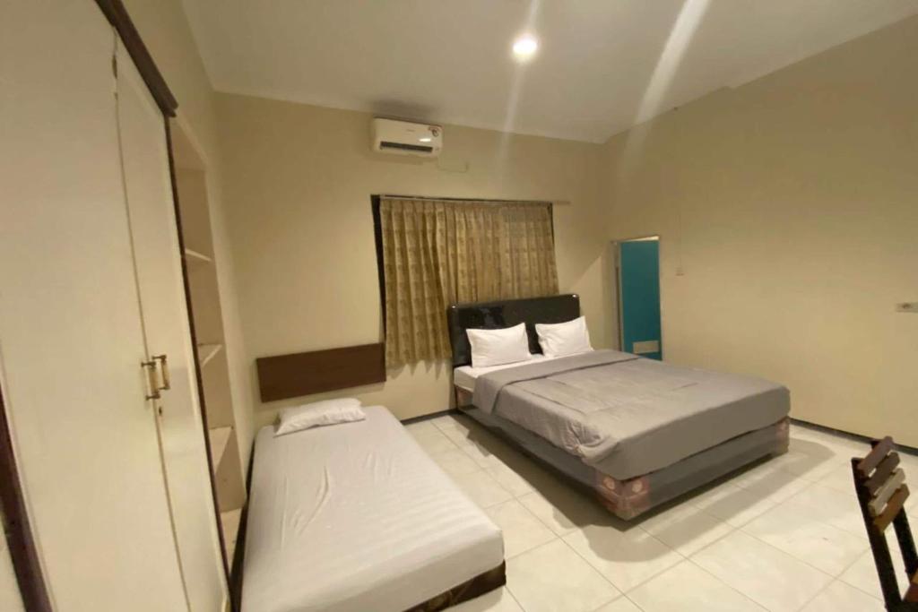 Postel nebo postele na pokoji v ubytování Sweet Home Residence Simpang Lima