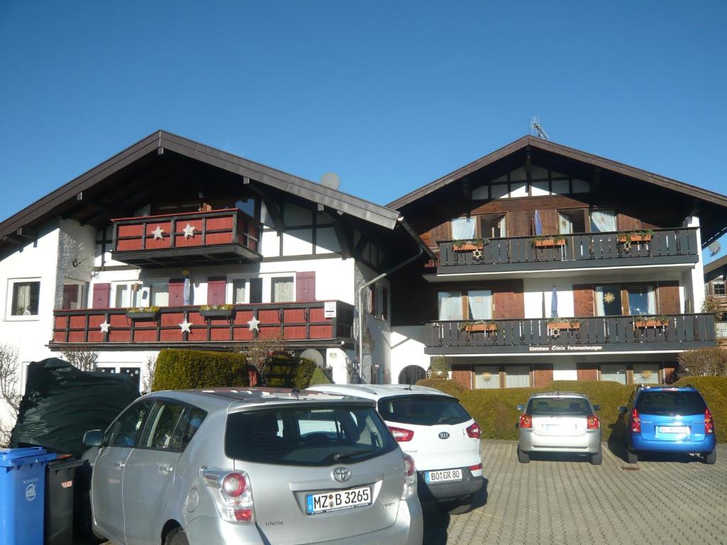 a parking lot with cars parked in front of buildings at Haus Stein in Oberstdorf
