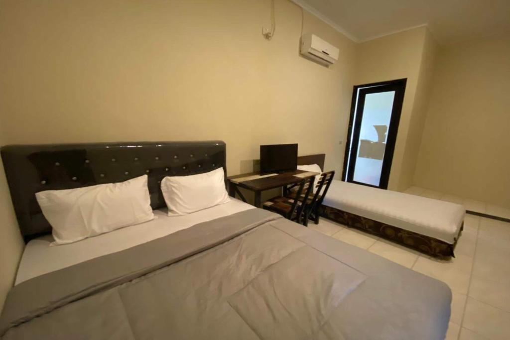 Postel nebo postele na pokoji v ubytování Sweet Home Residence Simpang Lima