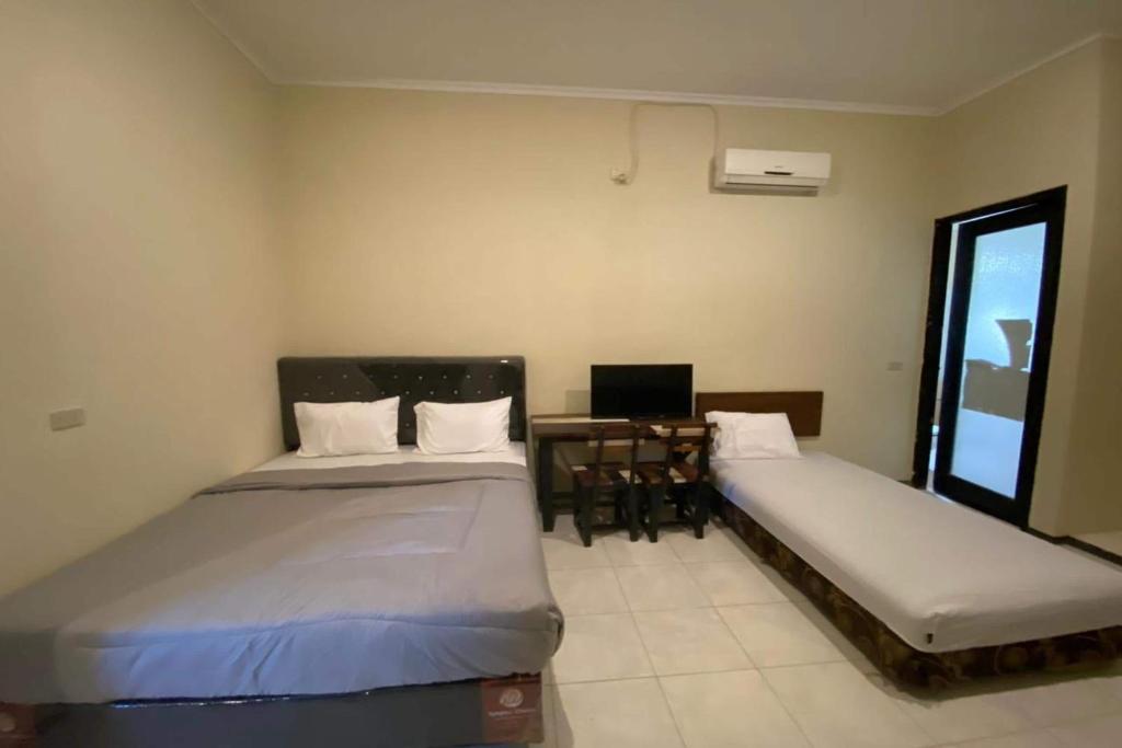 Postel nebo postele na pokoji v ubytování Sweet Home Residence Simpang Lima