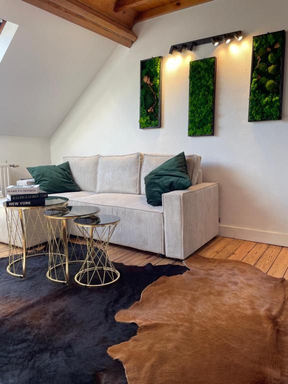 a living room with a couch and two tables at Attic European Quarter in Brussels