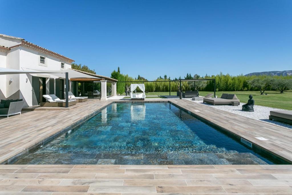 une piscine avec une terrasse et une maison dans l'établissement La Villa Suarela, à Cavaillon