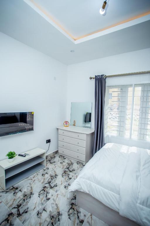 Postel nebo postele na pokoji v ubytování Aija Residences