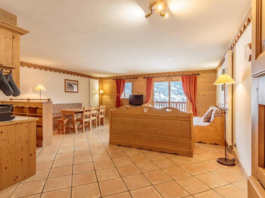 a kitchen and living room with a table and chairs at Appartement de standing 8 pers avec piscine, spa, parking inclus - FR-1-461-1 in Saint-Martin-de-Belleville