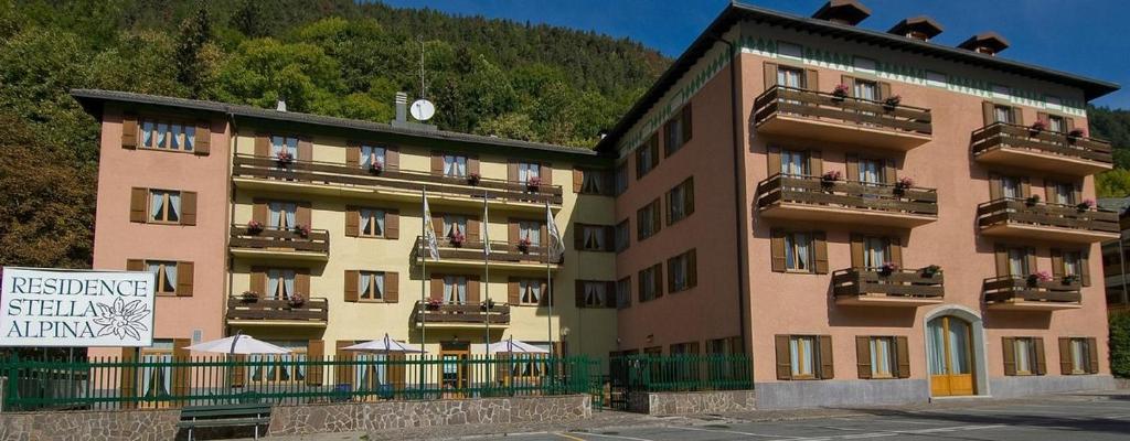 a large building with a sign in front of it at Residence Stella Alpina in Aprica