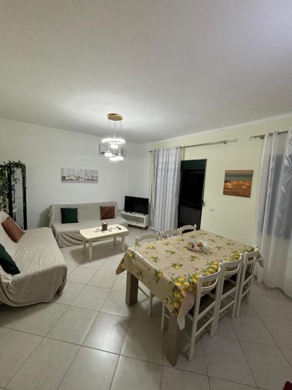a living room with a table and a couch at Matleo appartament in Golem