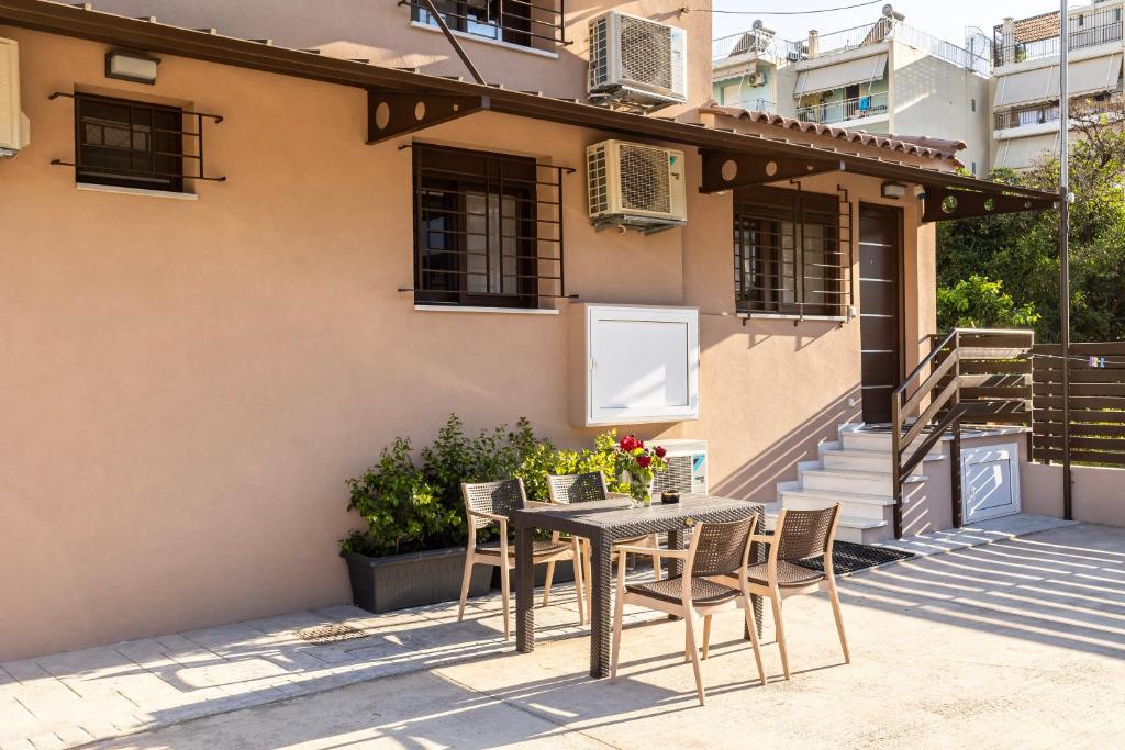 a patio with a table and chairs in front of a house at Grande Luxury Villa Kalamata - 3 in Kalamata