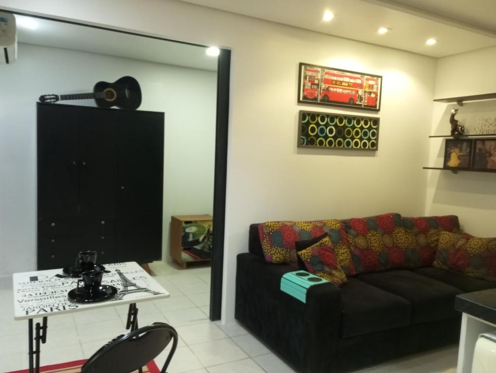 a living room with a couch and a table at Apartamento perto da Orla em frente ao Beira Rio in Porto Alegre