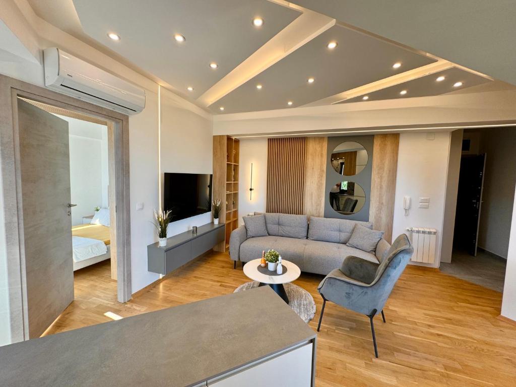 a living room with a couch and a table at Maria Luxury Apartment in Skopje