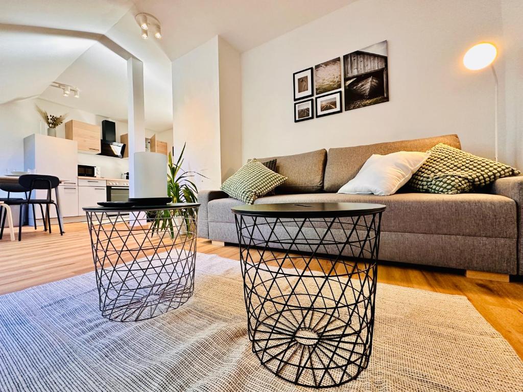 a living room with a couch and a table at Apartment Mirador an der Hohen Wand in NÖ in Grünbach am Schneeberg