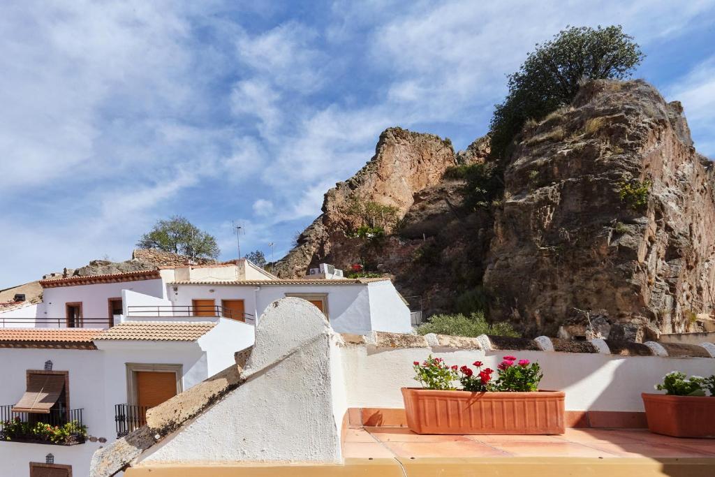 a house with a mountain in the background at Casa del Álamo in Cambil
