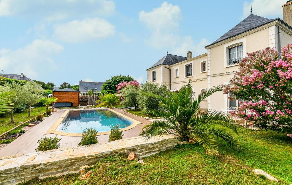 a house with a swimming pool in the yard at Beautiful Home In Saint-Cyr-Sur-Loire in Saint-Cyr-sur-Loire