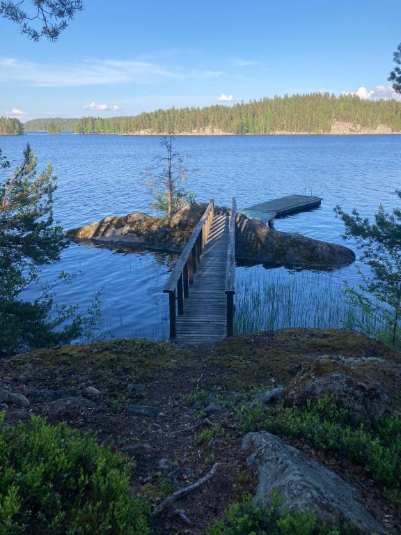 a wooden bridge over a large body of water at Willa Axe in Hurissalo