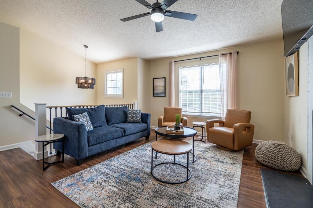 a living room with a blue couch and a table at Affordable 4-Bedroom Retreat Near DT Cartersville in Cartersville