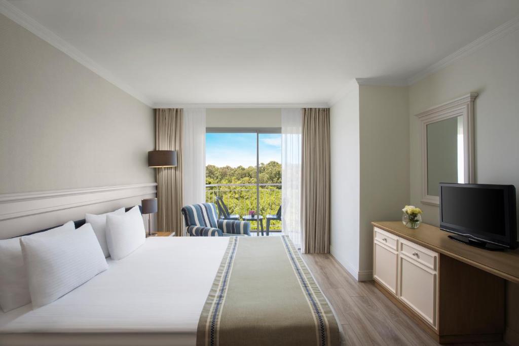 a hotel room with a bed and a television at IC Hotels Santai Family Resort - Kids Concept in Belek