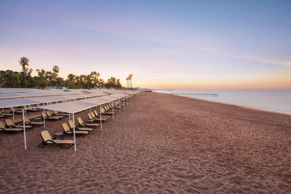 a long line of tables and chairs on the beach at IC Hotels Santai Family Resort - Kids Concept in Belek