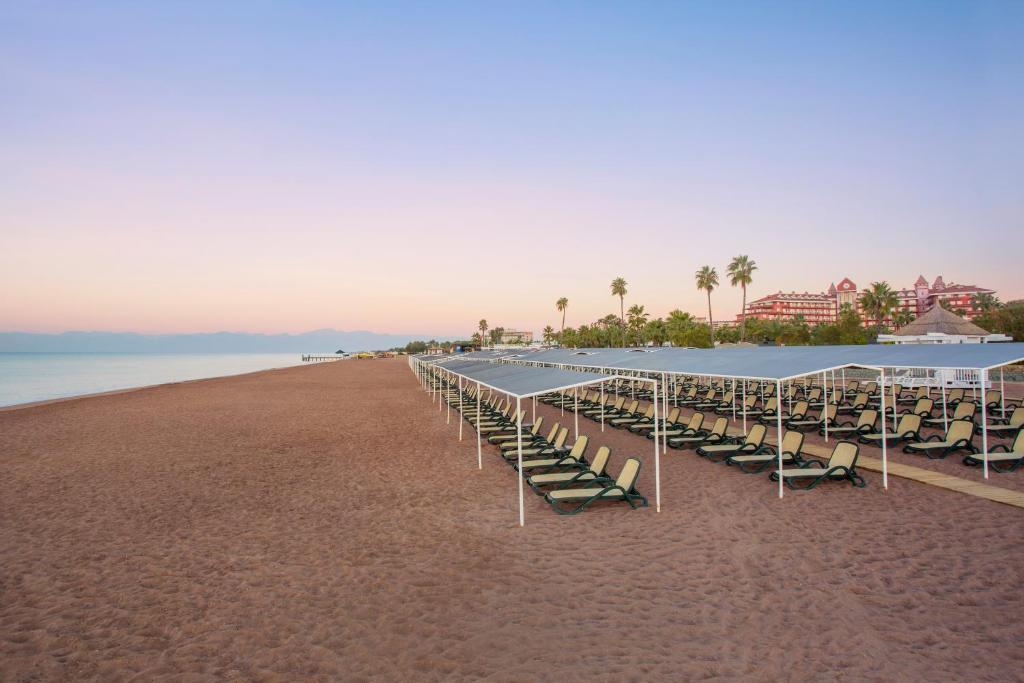 a group of tables and chairs on the beach at IC Hotels Santai Family Resort - Kids Concept in Belek