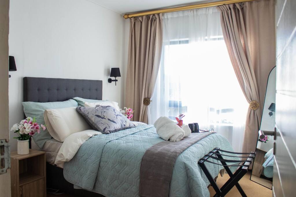 a bedroom with a bed with pillows and a window at City Break - Luxury Golf Estate & Country Club in Johannesburg