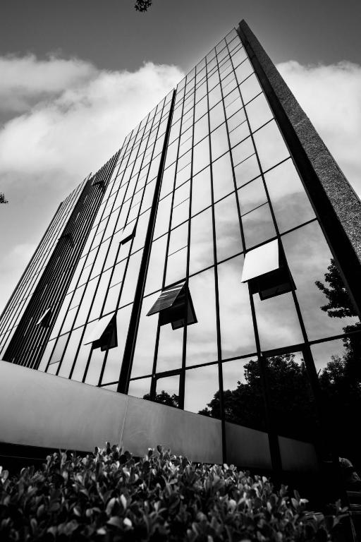a tall glass building with reflections in the windows at Hotel Stella Maris in Mexico City