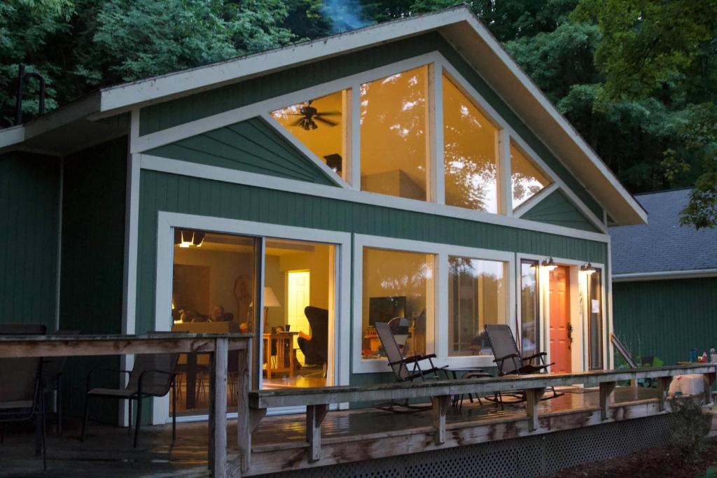 a green house with glass doors and windows at All Points North in Beulah