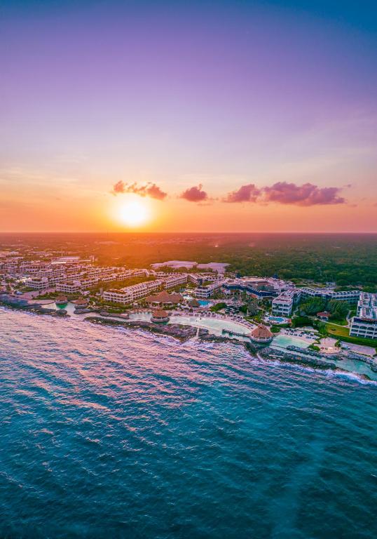 an aerial view of a beach at sunset at Hard Rock Hotel Riviera Maya - All Inclusive in Puerto Aventuras