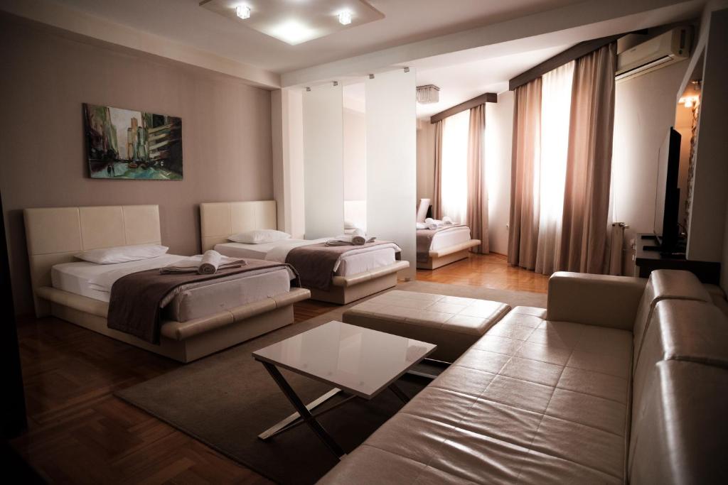 Postel nebo postele na pokoji v ubytování Garni Uni Elita Lux Hotel