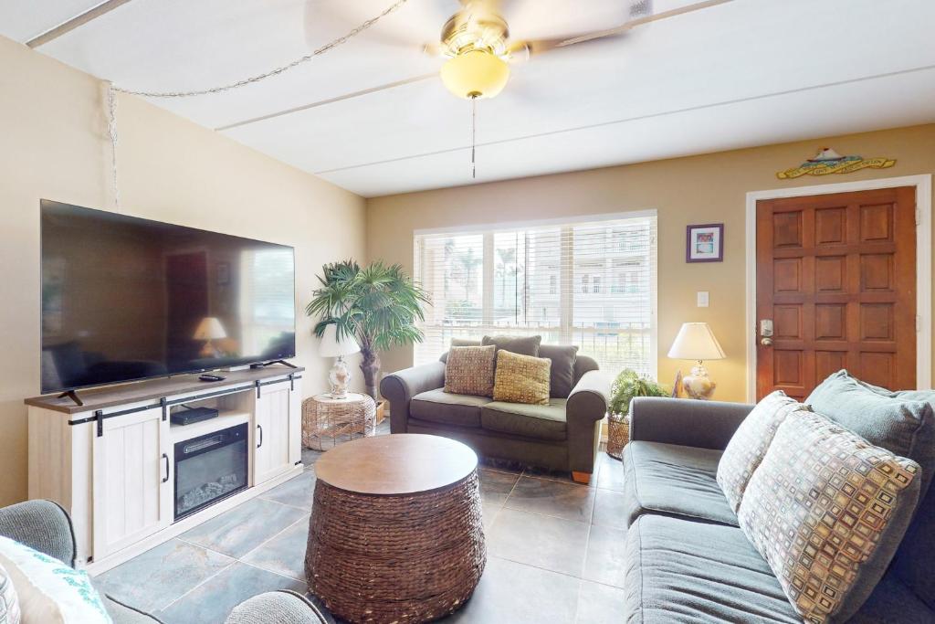 a living room with a large flat screen tv at Beachview Condominiums #111 in South Padre Island