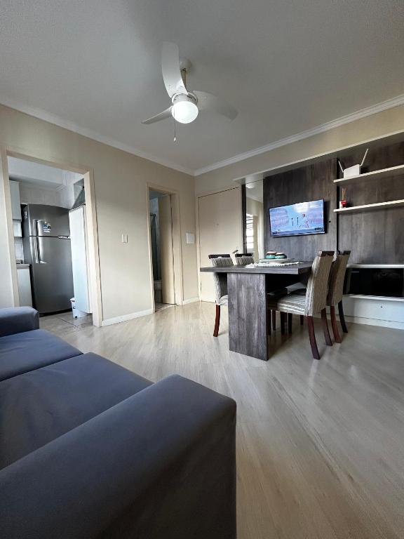 a living room with a table and a dining room at Lindo apt próximo ao consulado in Porto Alegre