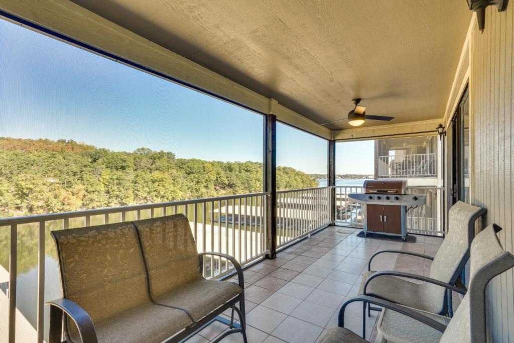a balcony with chairs and a table with a view at Waterfront Lazy Days Condo with Views and Pool Access! in Osage Beach