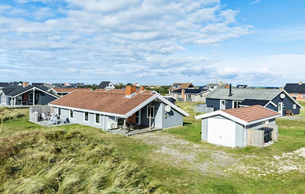 a group of houses on a grassy field at Pet Friendly Home In Thisted With Sauna in Thisted