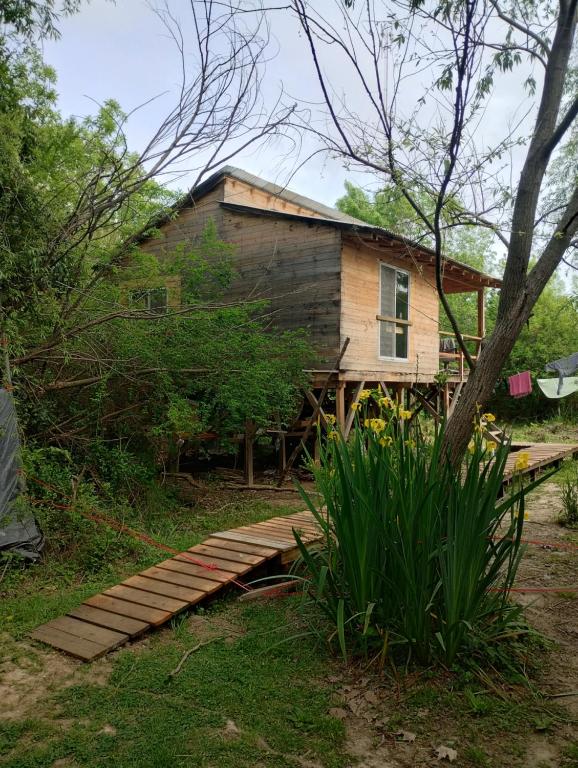 a house with a wooden walkway in front of it at Isla Curubica Premium in Tigre
