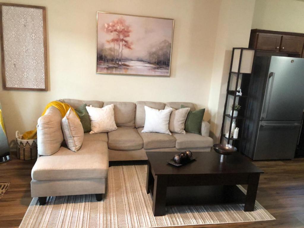 a living room with a couch and a coffee table at 4BR Cruise-Ready Home Walk to Moody Gardens Fenced Yard in Galveston