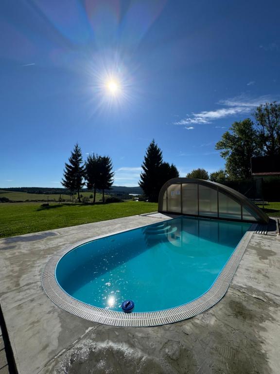 a swimming pool with a cover on top of it at Penzion Axiom in Frymburk