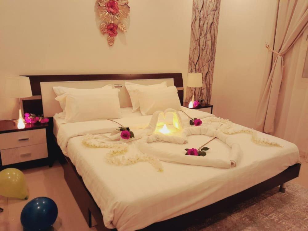 a bedroom with a large bed with flowers on it at فندق ظلال جدة in Jeddah
