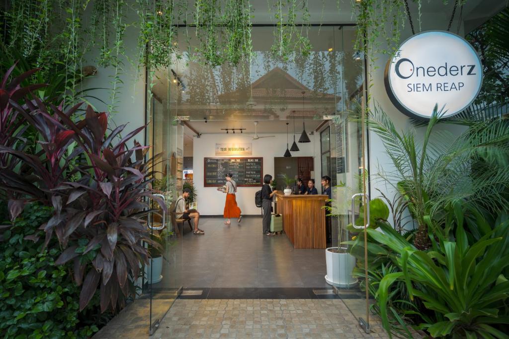 a lobby of a store with plants at Onederz Siem Reap in Siem Reap