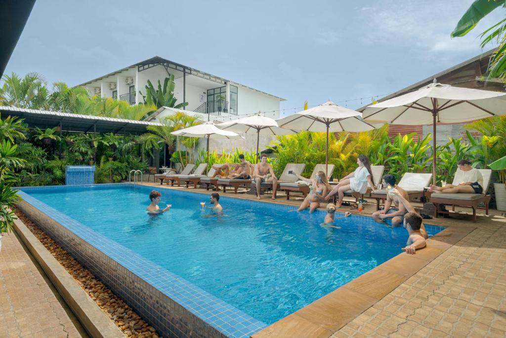 a group of people in a pool at a hotel at Onederz Siem Reap in Siem Reap