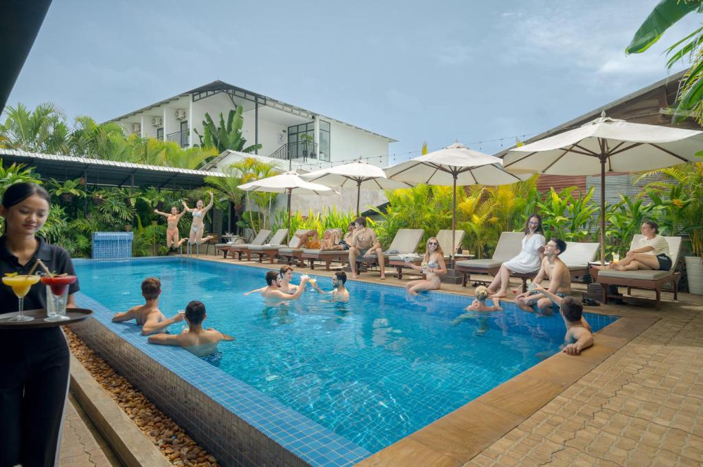 a group of people sitting in a swimming pool at Onederz Siem Reap in Siem Reap