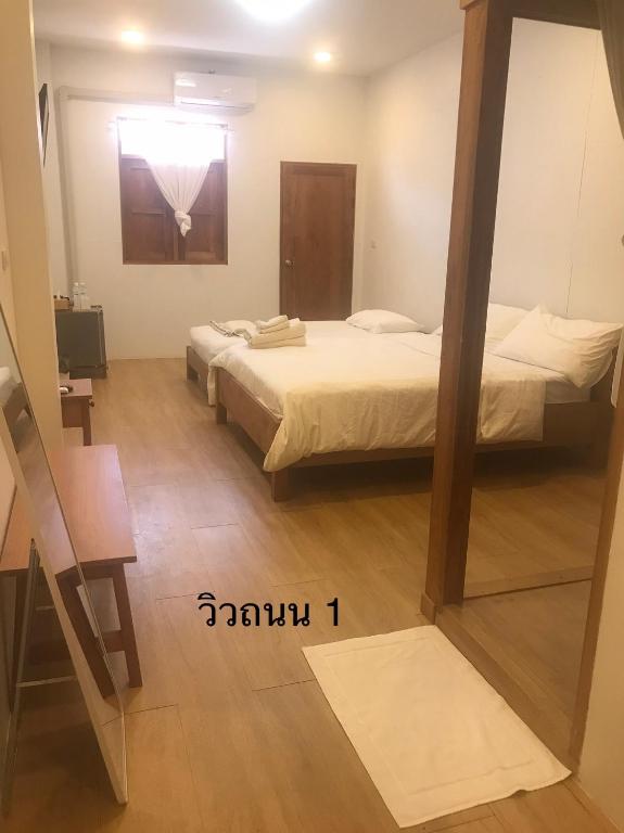 Postel nebo postele na pokoji v ubytování นา-ใบบุญ Nabaiboon