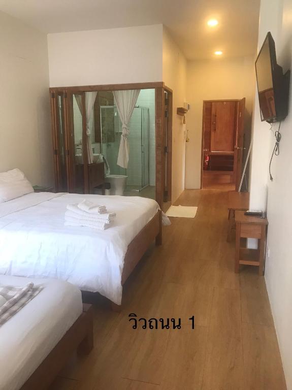 Postel nebo postele na pokoji v ubytování นา-ใบบุญ Nabaiboon