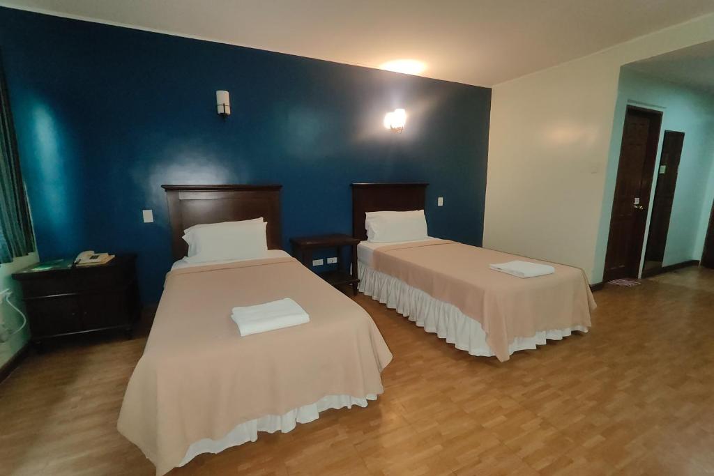 Postel nebo postele na pokoji v ubytování Oftana Suites Cebu near Oakridge