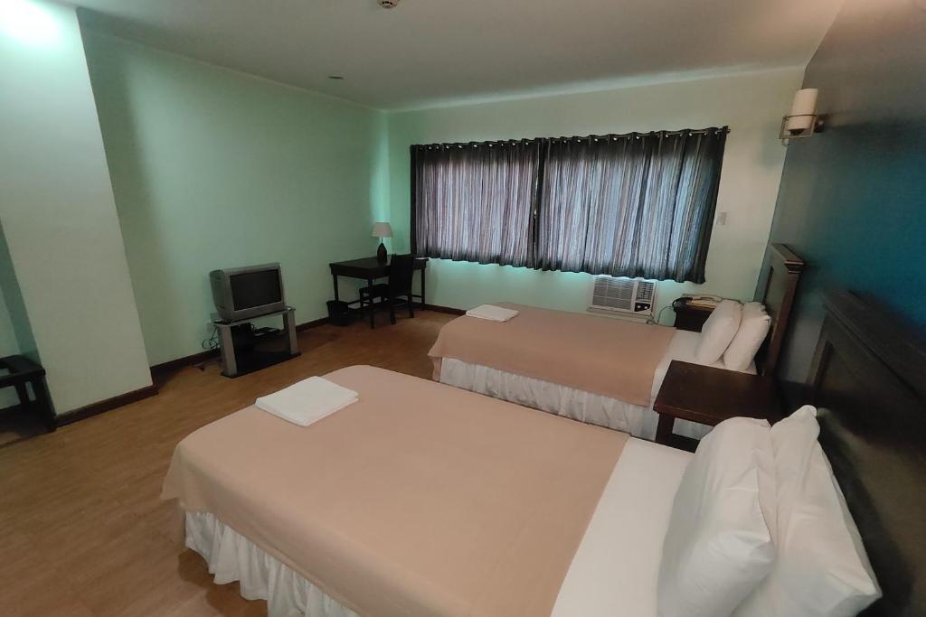 Postel nebo postele na pokoji v ubytování Oftana Suites Cebu near Oakridge