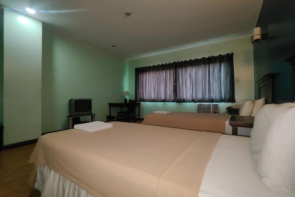 Postel nebo postele na pokoji v ubytování Oftana Suites Cebu near Oakridge