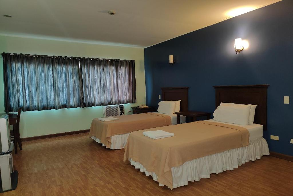 Postel nebo postele na pokoji v ubytování Oftana Suites Cebu near Oakridge