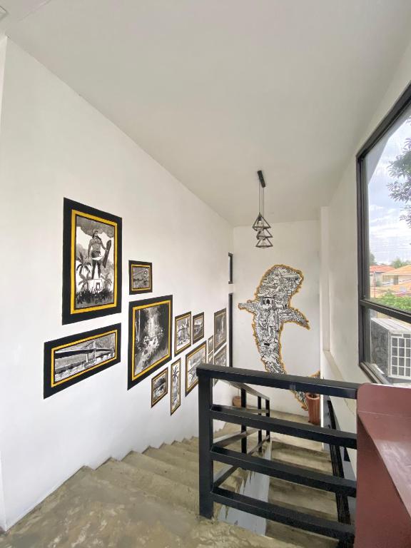a staircase in a house with pictures on the wall at The Pocket Hotel in Mactan
