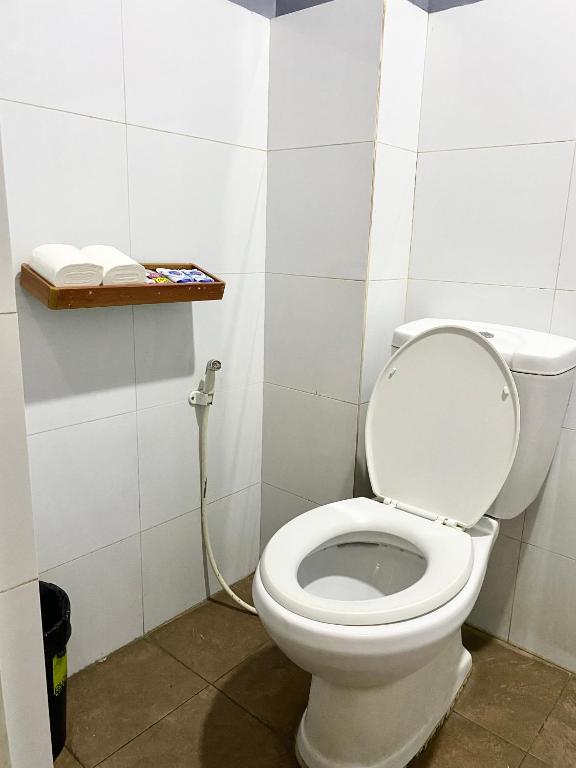 a bathroom with a white toilet in a room at The Pocket Hotel in Mactan