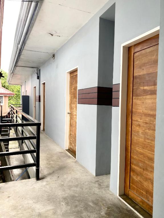a hallway of a house with a wooden door at The Pocket Hotel in Mactan