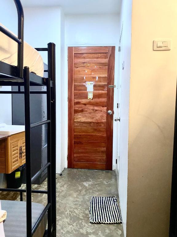 a room with a door and a bunk bed at The Pocket Hotel in Mactan